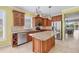 A well-equipped kitchen features wooden cabinetry, granite counters, and stainless steel appliances at 8356 Creekview Ln, Englewood, FL 34224