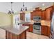 Bright kitchen offers ample counter space with stainless steel appliances and stylish pendant lighting at 8356 Creekview Ln, Englewood, FL 34224