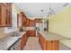A spacious kitchen showcases custom wood cabinets, granite countertops, and stainless steel appliances at 8356 Creekview Ln, Englewood, FL 34224