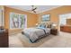 Bright main bedroom features a ceiling fan, neutral decor, and an ensuite bathroom at 8356 Creekview Ln, Englewood, FL 34224