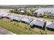 Back view of homes featuring a screened in back porch and beautiful greenery at 8562 Shore Lake Dr, Englewood, FL 34224