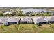 A beautiful aerial showcases rear elevations, barrel tile roofs, and lake views in a serene neighborhood setting at 8562 Shore Lake Dr, Englewood, FL 34224