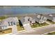 Lakefront community featuring single-story homes with lush landscaping and tile roofs at 8562 Shore Lake Dr, Englewood, FL 34224