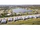 Panoramic aerial view of homes with a lake view, mature trees, and landscaping at 8562 Shore Lake Dr, Englewood, FL 34224