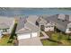 Beautiful aerial view of home with a 3-car garage and lush landscaping, near lake at 8562 Shore Lake Dr, Englewood, FL 34224