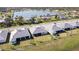 This aerial view highlights homes with barrel tile roofs, manicured lawns, and a picturesque lakefront setting at 8562 Shore Lake Dr, Englewood, FL 34224