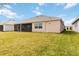 Spacious backyard featuring green grass and a view of a serene lake at 8562 Shore Lake Dr, Englewood, FL 34224