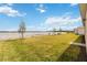 A lush green lawn extends to a beautiful lake view, enhancing the home's appeal at 8562 Shore Lake Dr, Englewood, FL 34224