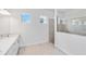 Bright bathroom showcasing tile floors, a double sink vanity, and glass-enclosed shower at 8562 Shore Lake Dr, Englewood, FL 34224