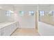 Bathroom featuring double sink vanity, tile floors, and glass-enclosed shower at 8562 Shore Lake Dr, Englewood, FL 34224