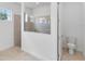 Bright bathroom featuring a glass-enclosed shower and modern toilet at 8562 Shore Lake Dr, Englewood, FL 34224