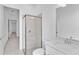 Bathroom showcasing a walk-in shower, white vanity, and a modern design at 8562 Shore Lake Dr, Englewood, FL 34224