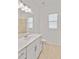 Bright bathroom features a white vanity, modern fixtures, and neutral tile flooring at 8562 Shore Lake Dr, Englewood, FL 34224