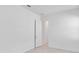 An empty room features white walls, tile floor, and a door that leads to the hallway at 8562 Shore Lake Dr, Englewood, FL 34224