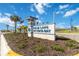 Palm Lake at Coco Bay community sign surrounded by beautiful landscaping and palm trees at 8562 Shore Lake Dr, Englewood, FL 34224