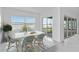 Bright dining room showcasing natural light, dining table, and serene water view at 8562 Shore Lake Dr, Englewood, FL 34224