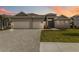 Beautiful single-story home with a three car garage and a well manicured lawn at 8562 Shore Lake Dr, Englewood, FL 34224