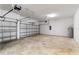 Spacious two car garage with updated garage door openers and a light colored floor at 8562 Shore Lake Dr, Englewood, FL 34224