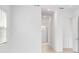 Bright hallway featuring tile floors, white walls, and doorways leading to other rooms at 8562 Shore Lake Dr, Englewood, FL 34224