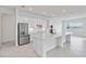 Modern kitchen with a long island, stainless steel appliances, and a bright, open layout at 8562 Shore Lake Dr, Englewood, FL 34224
