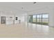 Spacious living room showcases an open layout, modern kitchen, and scenic outdoor views at 8562 Shore Lake Dr, Englewood, FL 34224