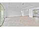 Expansive living room with neutral tones, tile flooring, and ample natural light at 8562 Shore Lake Dr, Englewood, FL 34224