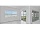 Living room with view of the lake through sliding glass doors at 8562 Shore Lake Dr, Englewood, FL 34224