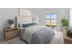 Cozy main bedroom features a calm color palette and sliding glass doors to the outside at 8562 Shore Lake Dr, Englewood, FL 34224