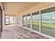 Covered patio features sliding glass doors offering seamless indoor/outdoor living with lake views at 8562 Shore Lake Dr, Englewood, FL 34224