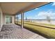 Screened in back patio overlooking a spacious lawn and stunning lake views at 8562 Shore Lake Dr, Englewood, FL 34224