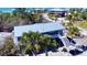 Aerial shot of a charming elevated home showcasing the surrounding landscape and architectural design with staircase at 8694 Marsh St, Placida, FL 33946