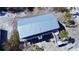 Birds-eye view of elevated coastal home featuring stairs, landscaping and a durable metal roof in a serene setting at 8694 Marsh St, Placida, FL 33946