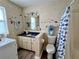 Well-lit bathroom with a tiled shower and stylish fish-themed accessories at 8694 Marsh St, Placida, FL 33946