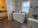 Bathroom and laundry room with tiled walls and modern appliances for added convenience at 8694 Marsh St, Placida, FL 33946