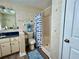 Bathroom with shower, tile flooring, under-sink storage and matching fish themed accessories at 8694 Marsh St, Placida, FL 33946