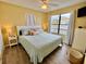 Well-lit main bedroom with a queen bed, matching nightstands, and beachy decor at 8694 Marsh St, Placida, FL 33946