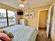 Sunny main bedroom boasts beach-themed decor, wood floors, and a spacious closet at 8694 Marsh St, Placida, FL 33946