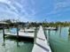 Dock view featuring boats and a serene waterfront under a beautiful blue sky at 8694 Marsh St, Placida, FL 33946