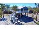 Inviting coastal home with wraparound porch, staircase, standing on pilings amongst a lush tropical landscape at 8694 Marsh St, Placida, FL 33946