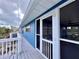 Charming blue exterior of a beach house with a welcoming porch and white railings at 8694 Marsh St, Placida, FL 33946