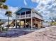 Inviting stilt home with a ground level bar, complete with a grill, and outdoor space for entertaining at 8694 Marsh St, Placida, FL 33946