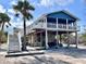 Coastal stilt home with a bar area underneath, perfect for entertaining and enjoying the beach lifestyle at 8694 Marsh St, Placida, FL 33946