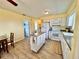 Spacious kitchen with island, breakfast bar, and white appliances, perfect for preparing meals and entertaining at 8694 Marsh St, Placida, FL 33946