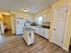 Bright kitchen with white appliances, wood floors and an island at 8694 Marsh St, Placida, FL 33946