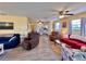 Bright and airy living room with comfortable seating, ceiling fans, and a view into the kitchen at 8694 Marsh St, Placida, FL 33946