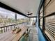 Relaxing screened porch featuring an elegant dining table, seating and views of the surrounding greenery at 8694 Marsh St, Placida, FL 33946