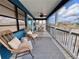 Inviting screened porch featuring wicker chairs, ceiling fan and outdoor dining area at 8694 Marsh St, Placida, FL 33946