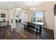 Entryway and dining area featuring wood floors, a chandelier, and a large window at 9087 Hilliard Ter, Englewood, FL 34224