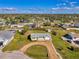 Charming one-story home featuring a circular driveway and a well-manicured lawn in a serene neighborhood at 91 Beverly Cir, Englewood, FL 34223