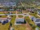 Aerial view of a home in a residential area with mature trees and landscaping at 91 Beverly Cir, Englewood, FL 34223